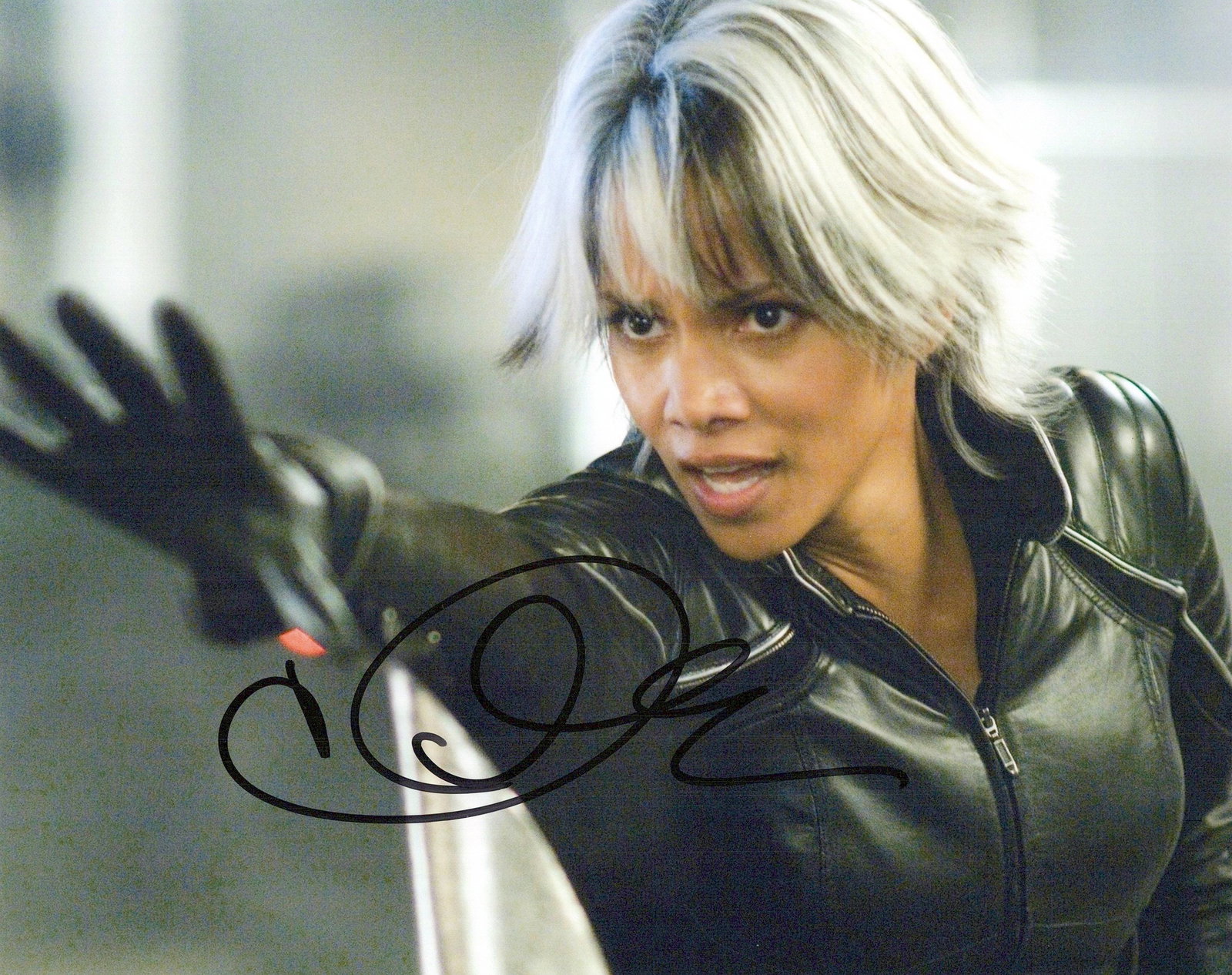 Halle Berry X-MEN In Person Signed Photo: Photo size is 8x10. Halle Berry in person signed autographed photo from the movie X-MEN. Halle Berry as the character Ororo Munro / Storm