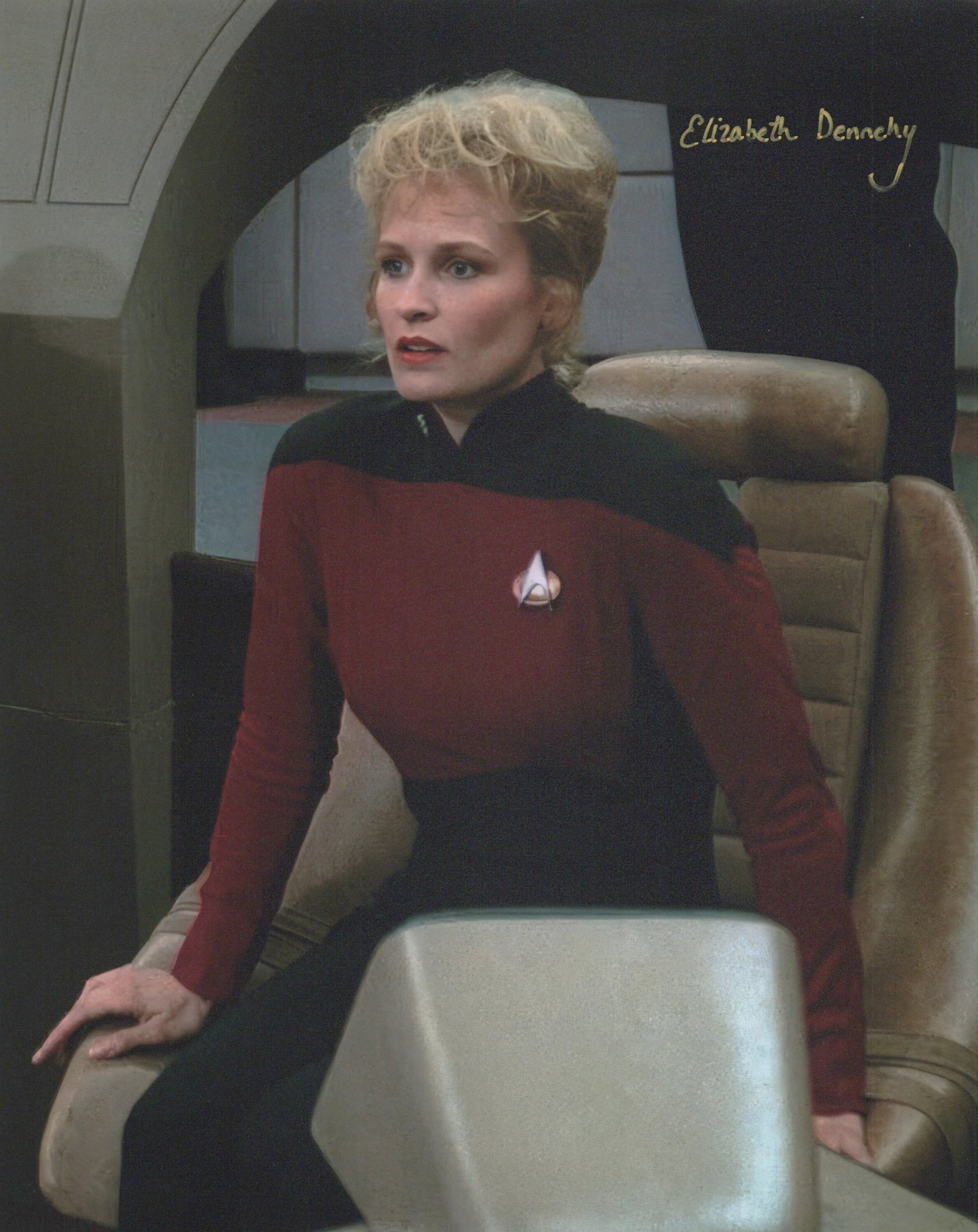Elizabeth Dennehy STAR TREK: NG In Person Signed Photo: Photo size is 8x10. Elizabeth Dennehy in person signed photo from the TV series STAR TREK THE NEXT GENERATION. Elizabeth Dennehy as the character Lieut. Cmdr. Shelby