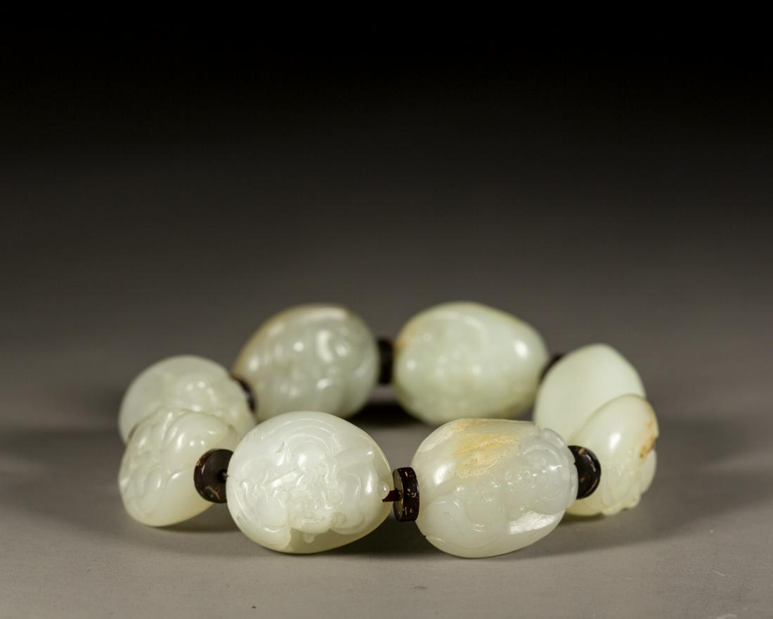 A CHINESE WHITE JADE BUDDHA BRACELET, 7 BEADS, QING DYNASTY (1 of 5)