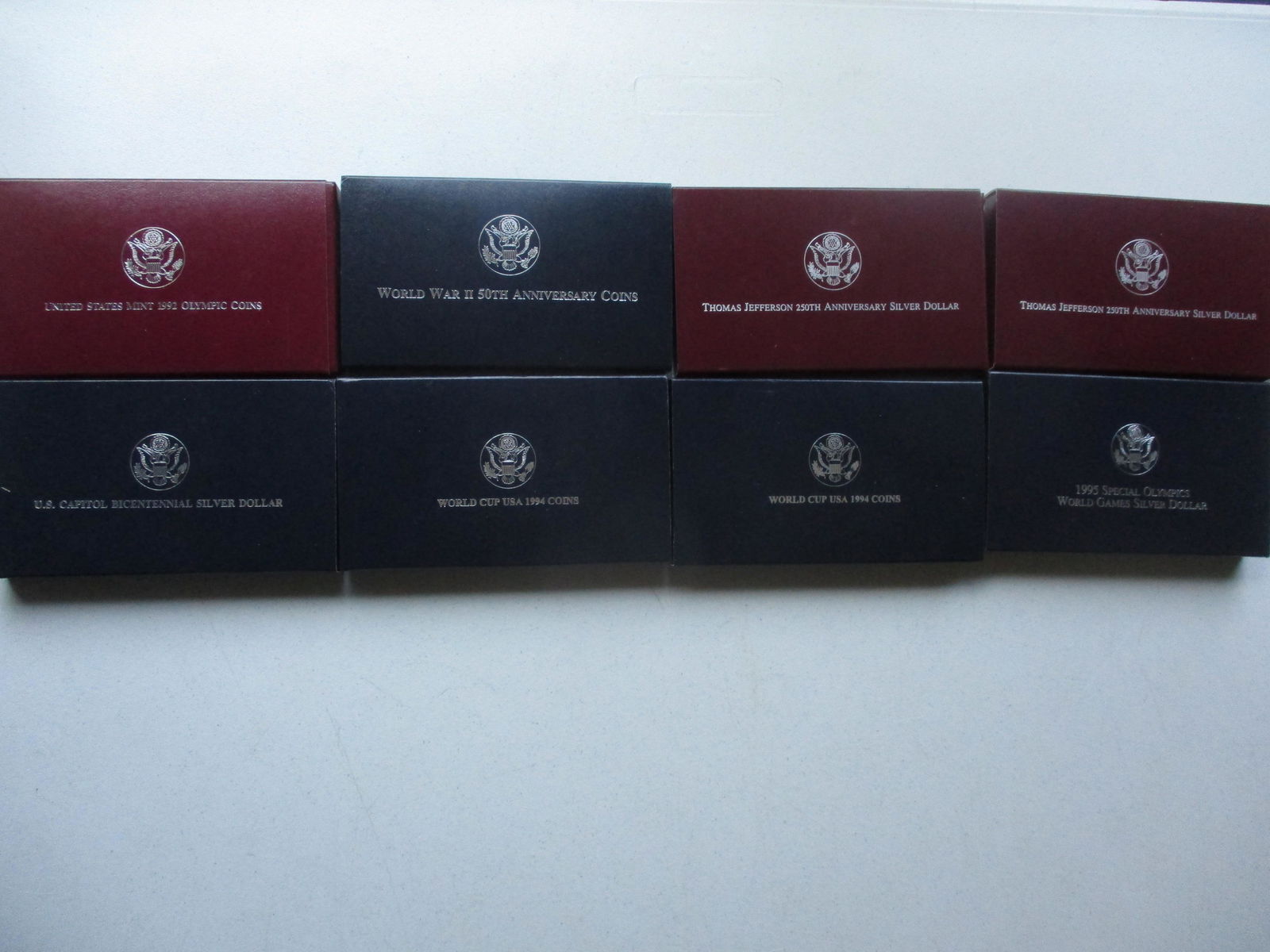 1991-1995 Commemorative Silver Coins: 1992 Olympic 2 Coin Set, 1991-1995 World War II 50th Anniverasary 2 Coin Set, (2) 1993 Thomas Jefferson 250th Anniversary Silver Dollars, U.S. Capital Bicentennial Silver Dollar, (2) 1994 World Cup 2