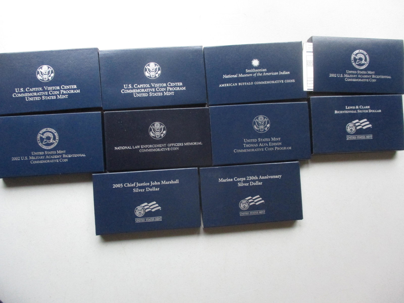 1997 and 2000's Commemorative Silver Coins: 2001 U.S. Capital Visitor Center Silver Dollar, 2001 Capital Visitor Center Clad Half Dollar (missing some packaging), (2) 2002 Military Academy Bicentennial Silver Dollars, 2001 American Buffalo 2 Co
