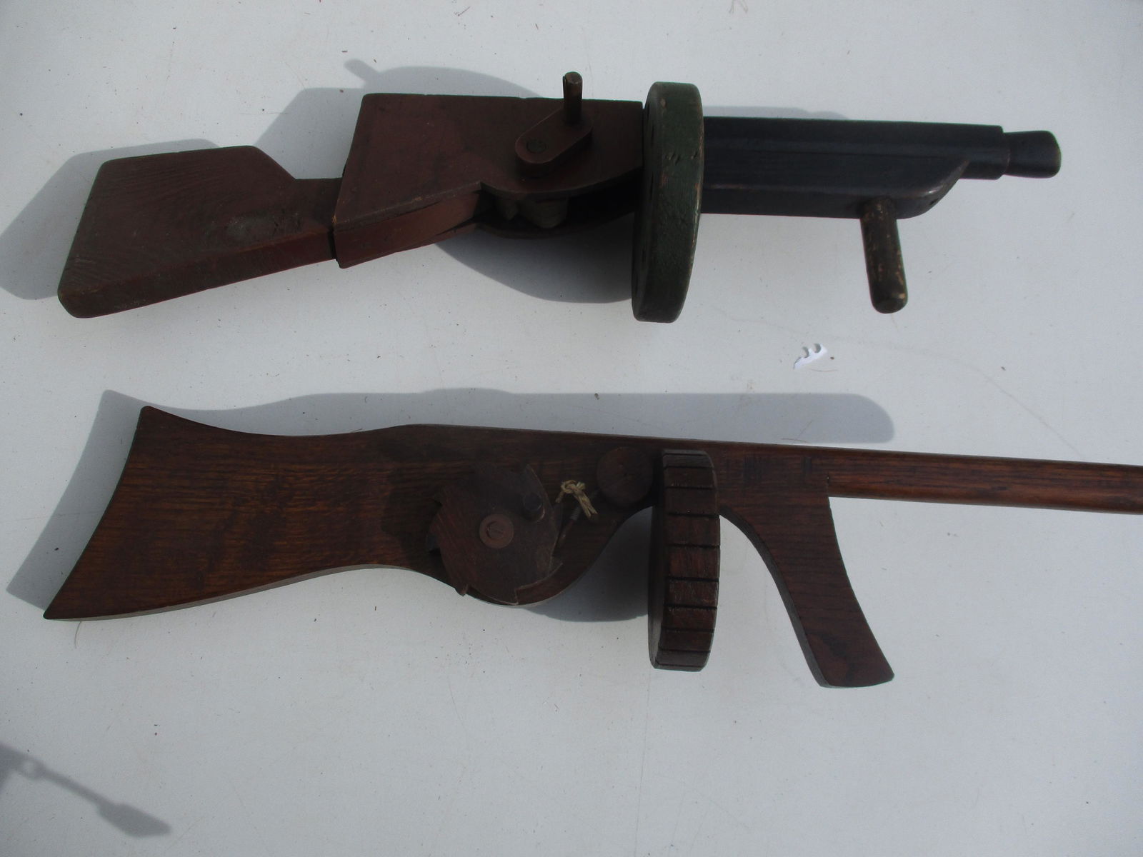 2 Folk Art Tommy Guns: Both have Cylinders to Mimic shots being fired one with Green Cylinder