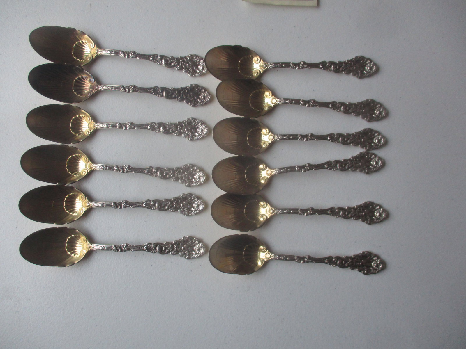 12 Gorham Sterling Cherub Gold Wash Spoons: Versailles Cherub Copyrighted 1888, Appr. 10.7 troy ounces - See photos for condition and details