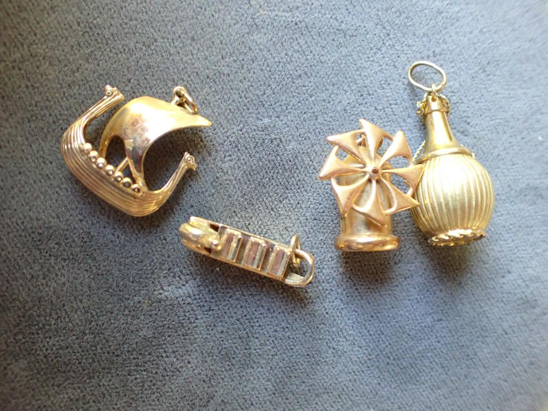 18 K 750 Windmill Charm and 3 Other 14k Charms: 18K - Appr. 3 Grams, 15k - Appr. 7 Grams - Total Appr. 10 Grams. Please see photos for details and condition.