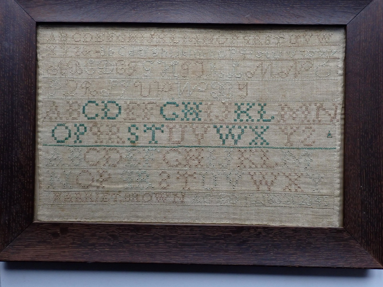 Sampler by Harriet Brown, Aged 12 Done in 1832: Oak Frame. Sampler: 10 1/2" x 16". Frame: 14" x 19". See photos for condition and details. Local pick-up available on February 4th or 3rd party shipping available. Please see terms.