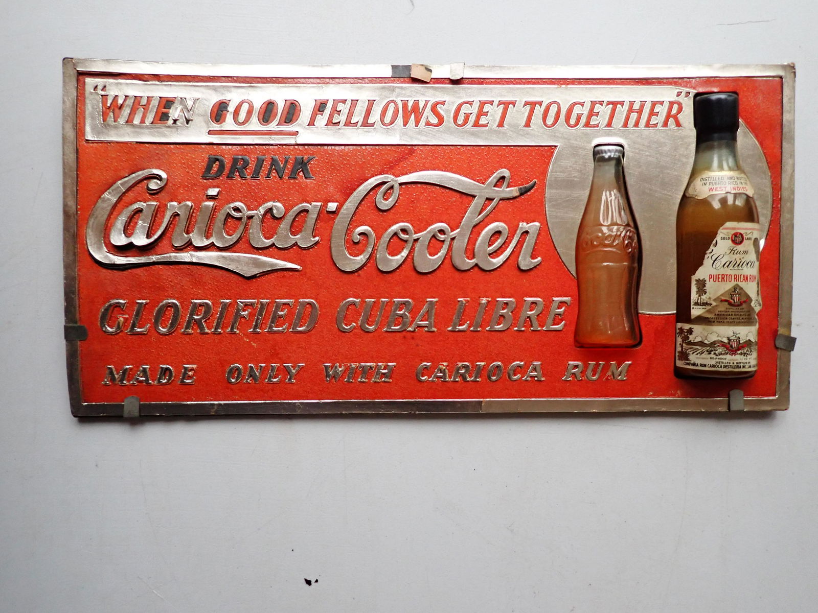 Carioca- Cooler "Glorified Cuba Libre" Advertising Sign: Made only with Carioca Rum Advertising Sign. Cardboard with Plastic Rum and Coke Bottles. "Where Good Fellows Get Together" 6" x 12 1/2". See photos for condition and details. Local pick-up available