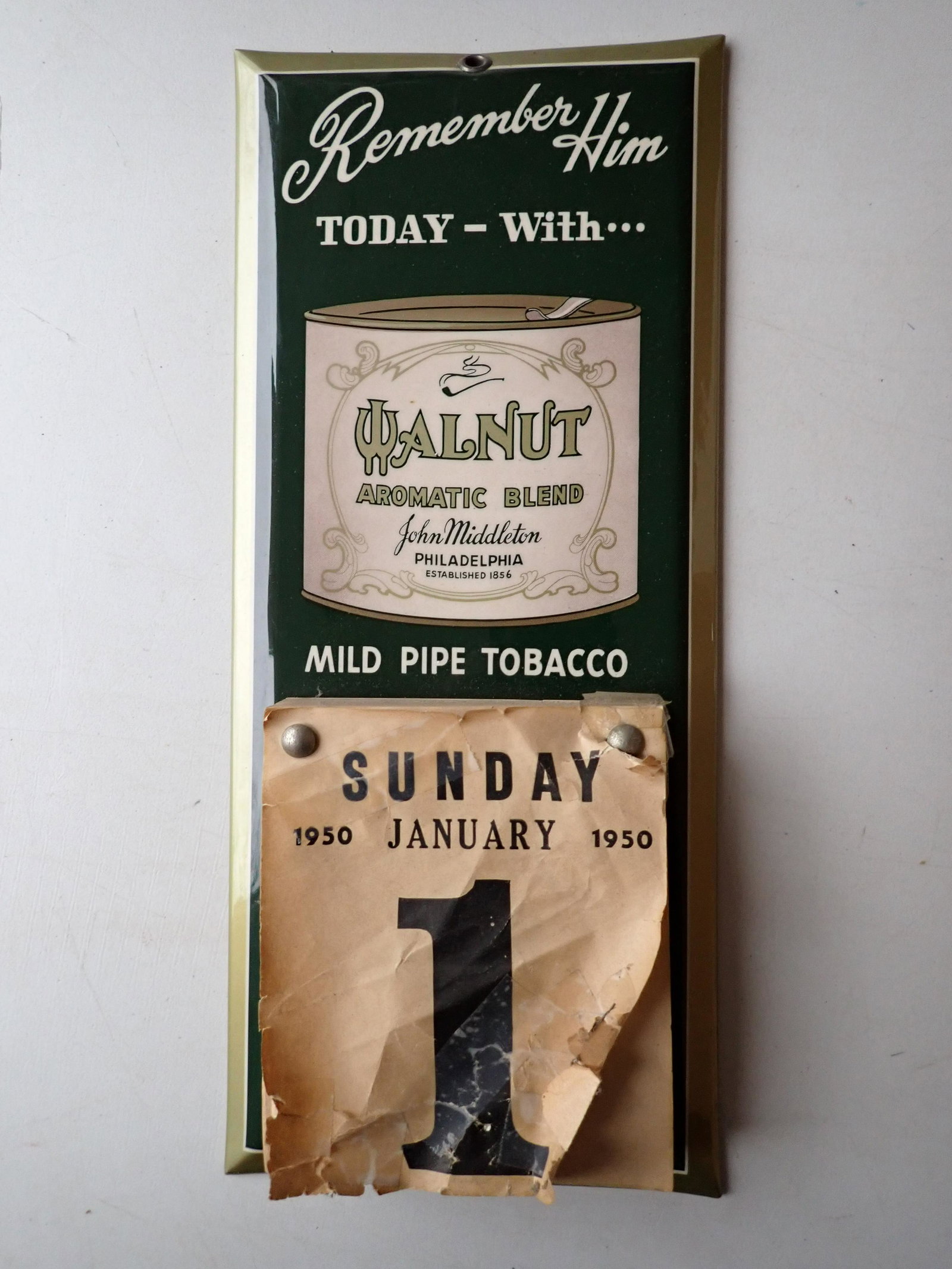Walnut Automatic Blend Mild Pipe Tobacco Metal Advertising: Calendar. Says "Remember him today with Walnut Rum Automatic Blend. 1950 Calendar with Full Paid. Jan. 1st page has been taped together. 13" x 6". See photos for condition and details. Local pick-up a