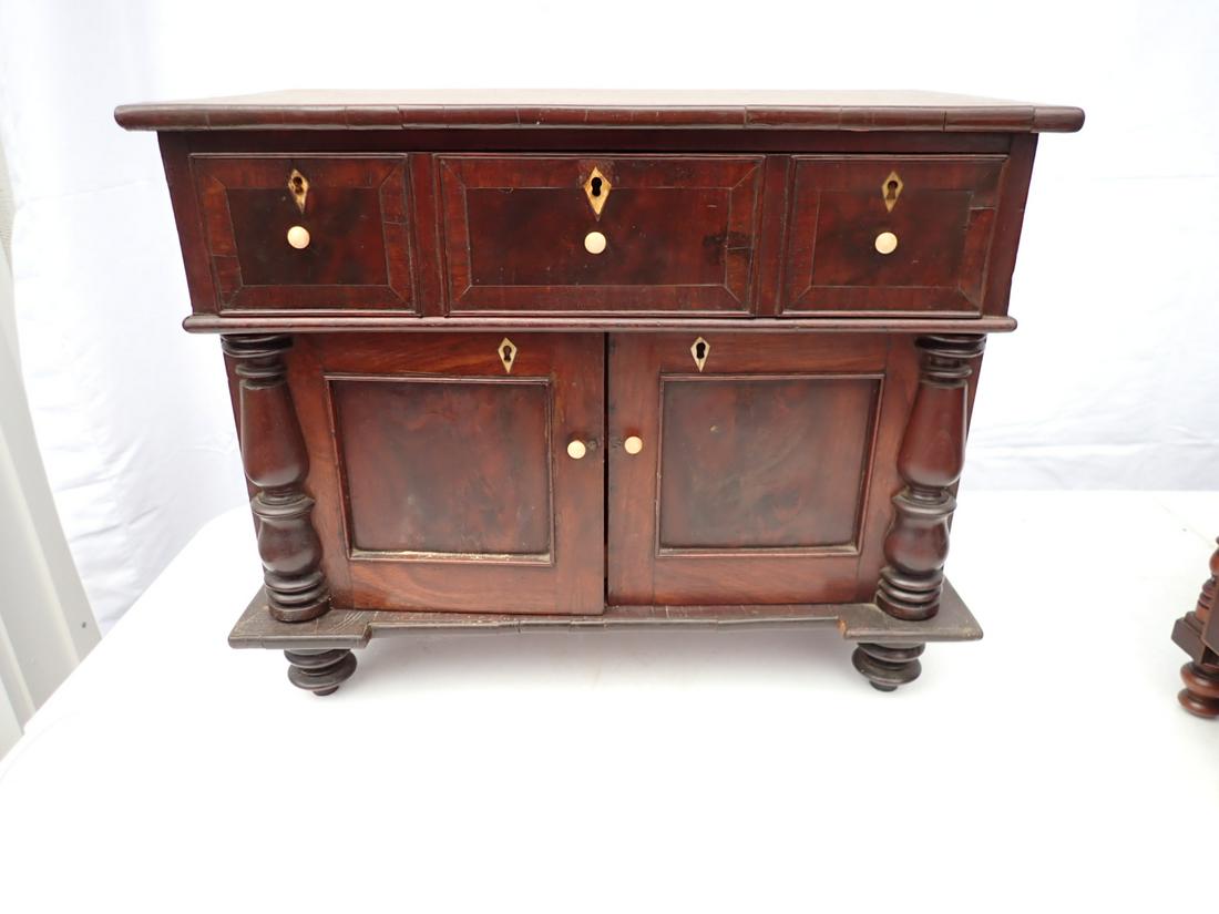 Antique Miniature Sideboard. 1 Drawer over 2 Door.: 2 Pull out sliding trays. Mahogany veneer and bone pulls. Veneer has some splitting but overall good condition. 15" high x 18" wide by 10" deep. Local pick-up available on February 4th or 3rd party sh