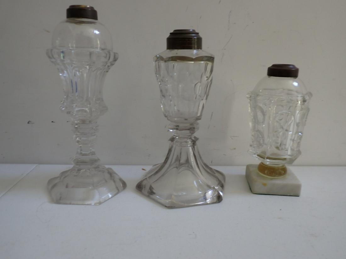 3 EABP Early American Pattern Glass Whale Oil Lamps: 9", 8 1/2" and 7". Small one has chip. See photos for condition and details Local pick-up available on February 4th or 3rd party shipping available. Please see terms.