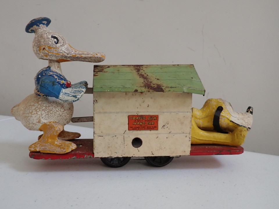 Donald & Pluto on Lionel Hand Car #1107.: The Lionel Corp. NY. 11" Long. Some paint loss, moves freely. Dog house roof has a little surface rust.