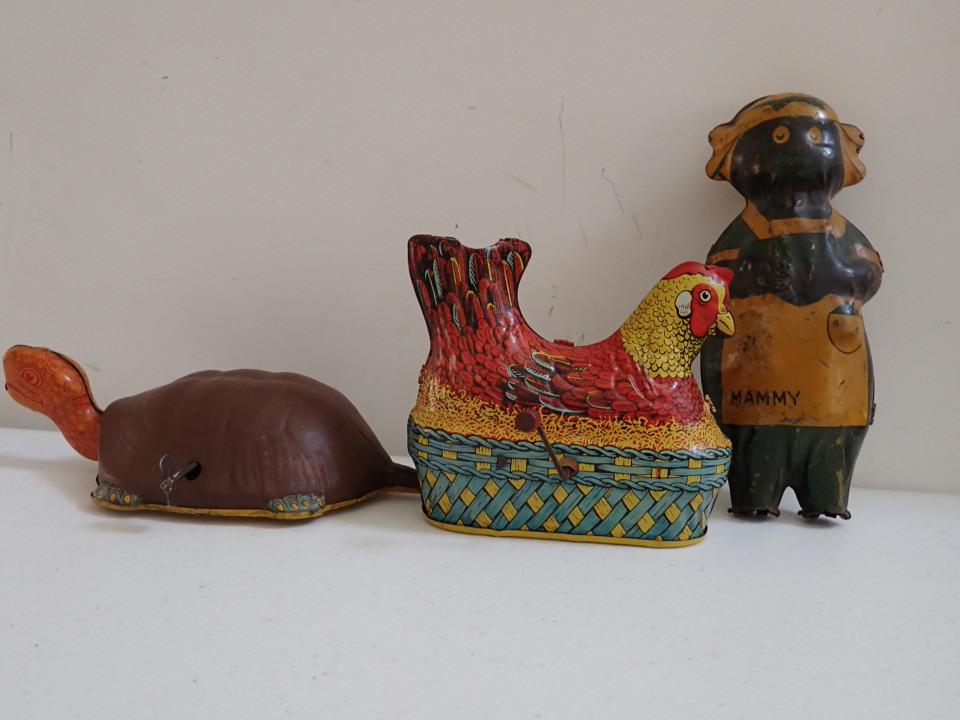 3 Tin Windup Toys. Chicken, Turtle and "Mammy" Figure: The chicken is made by Baldwin Mfg. Co. NY Patent # 2,151,330. 5 1/2" Long. Working Condition. Clucks when wound and has hole for eggs, but no eggs. Overall good condition. Turtle is in working condit