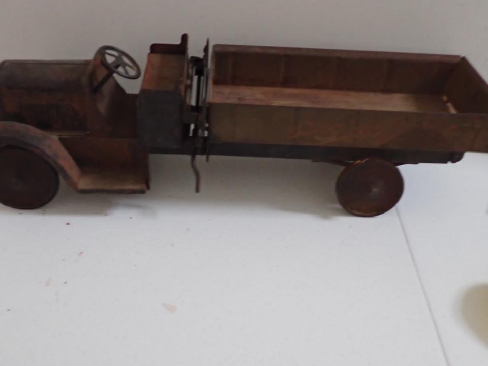 Dump Truck, Pressed Steel.: 25" Long. Oxidation and rust. One Wheel has no rubber, one is worn.