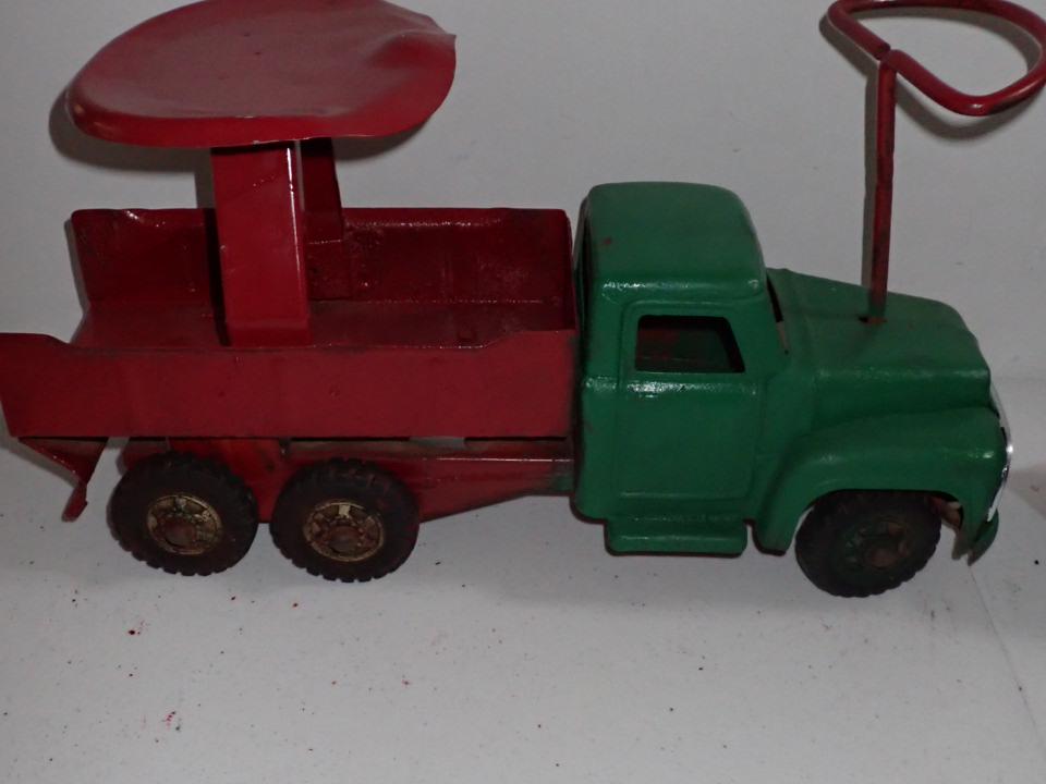 Buddy L Pressed Steel Riding Truck.: 19" Long. Seat is 10" tall. Rust on under carriage. Steering works. Has been repainted.