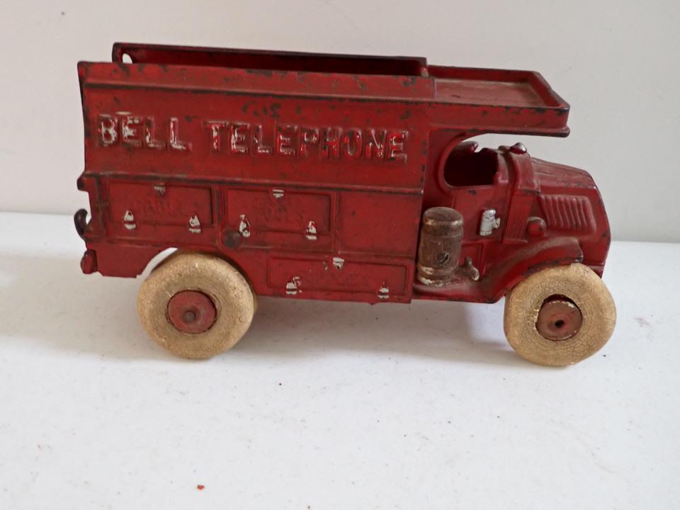 Bell Telephone Cast Iron Truck. Made in USA: 10". Stamped 2011. Some flattening on rubber wheels. Some paint loss.
