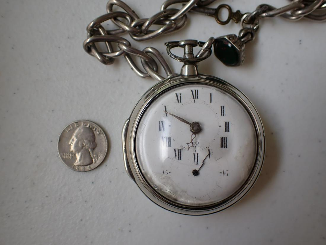 Large English Silver Pocket Watch with Chain. Has key: Has wear on dial with second hand missing. Some chipping inside Crystal. Chain has green colored stone.