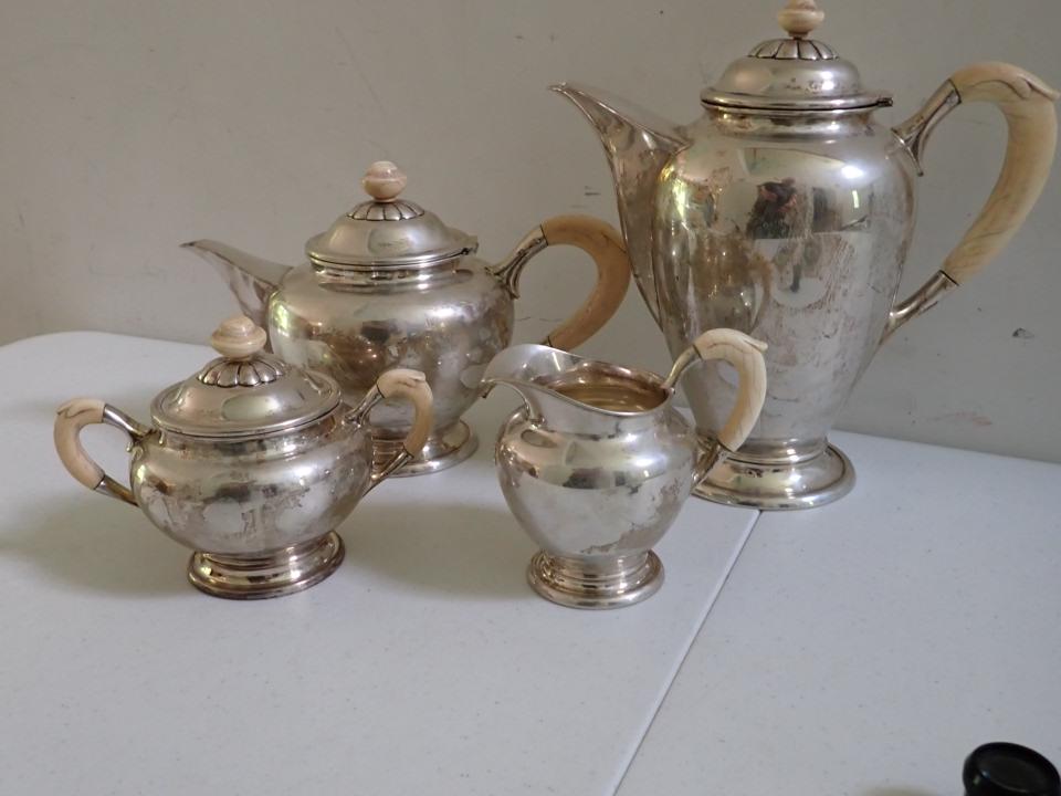 Silver Coffee & Tea Set with Bone Handles Marked .800 - 57.5 Troy ounces: Weighed with handles. Coffee Pot is 9 1/2". Teapot is 6 1/2". Creamer is 4 1/2" and Sugar is 4 1/2". Bone handles have some age cracks.