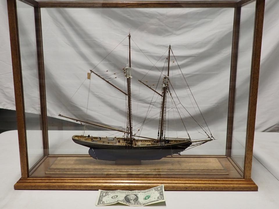 Wooden Finely Crafted 2 Mast Schooner in Glass Case: 16" wide x 14" high including base. Case: 22" wide x 18" high x 7" deep.