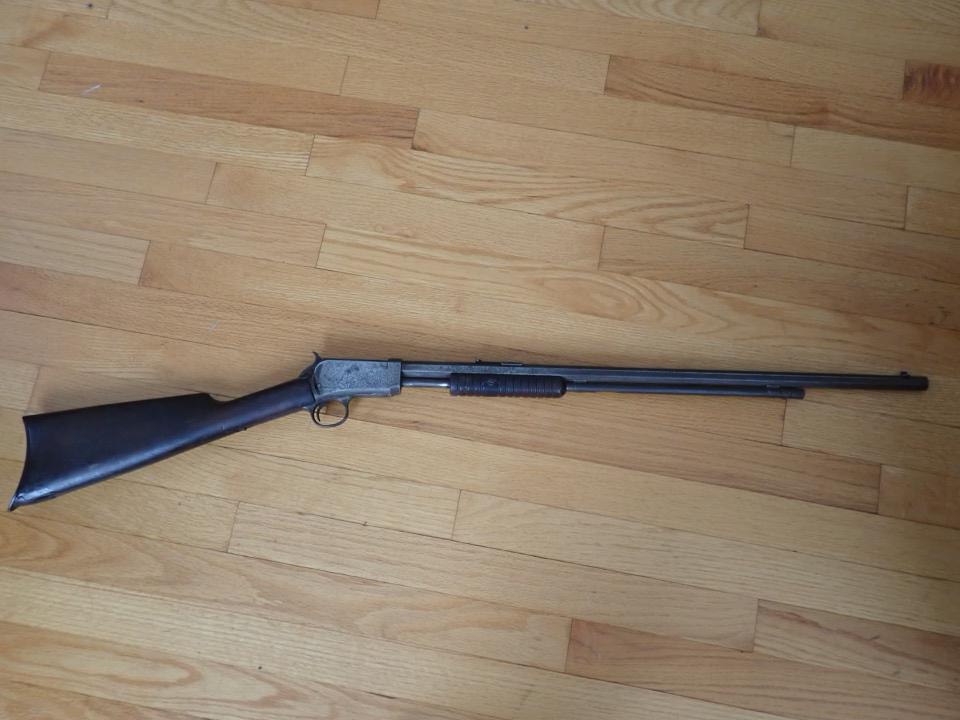 Winchester 22 Caliber Pump Rifle with Hexagonal Barrel: Marked #794484 Mechanism works. Overall Length 40". Barrel 23 1/2". Has some pitting and stock has wear and repair to bottom of stock.