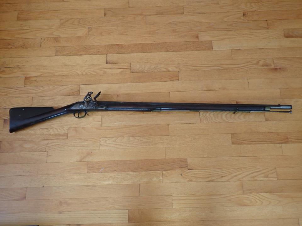 British Tower GR Hallmark Flint Lock Rifle: Rifle has engraved Crown with G.R. & Tower. Has other hallmarks on top of Barrel. Looks to be Enfield rifle.TH Engraved in Stock. Overall Length 55". Barrel 39". Wood has nicks. Barrel shows some wear