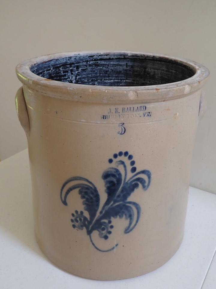 5 Gallon A.K. Ballard Burlington, VT Stoneware Crock. Cobalt: Blue Floral Design. Has chips along top edge. Small nicks. 12 1/2" high. 12" diameter.