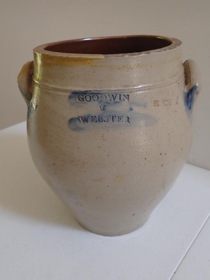Goodwin & Webster Ovoid Stoneware Crock: Cobalt on lettering and handles. Has a couple of nicks and yellow glaze around part of rim.