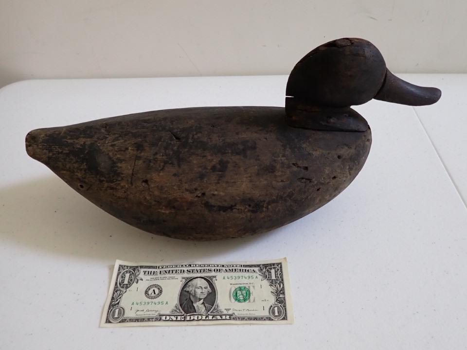 Antique Duck Wooden Decoy: 15" wide. Has partial horseshoe on bottom for weight. Has rose-head nail on head and shows some wear consistent with age.