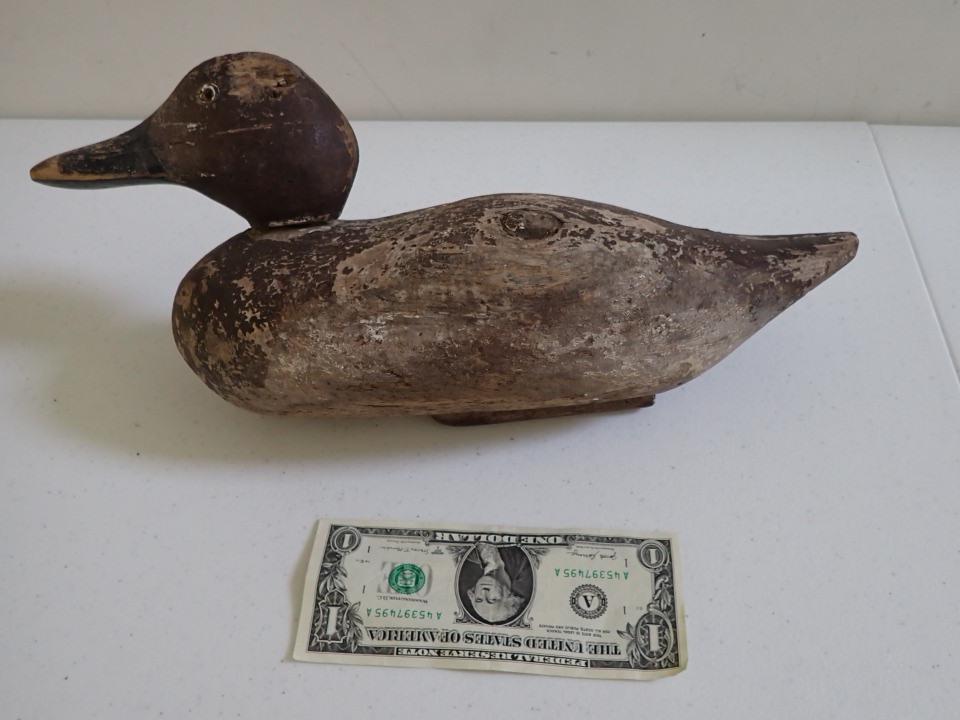Vintage Wooden Duck Decoy. Brown with Black Beak. Glass: Eyes. 14". Head swivels and is detachable. Wood has knot hole. Split in back.