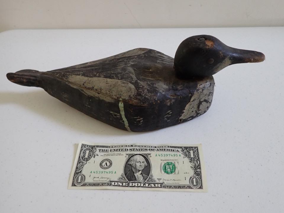 Vintage Wooden Duck Decoy. Wooden Diamond Shaped: Carved Tail Feathers. Pivoting Head. Metal Eyes. 13 1/2". Has old wooden nail on top of head.