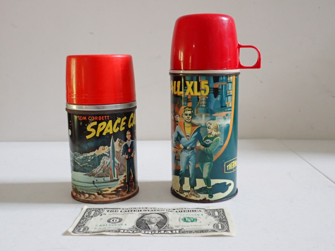 Tom Corbett Space Cadet and Fireball XL5 Thermos: 1952 Aladdin Tom Corbett Thermos has some surface rust on base and edges. Cup has a crack and some wear. 1964 Fireball XL5 Thermos has some surface rust along base. Cup has some wear.