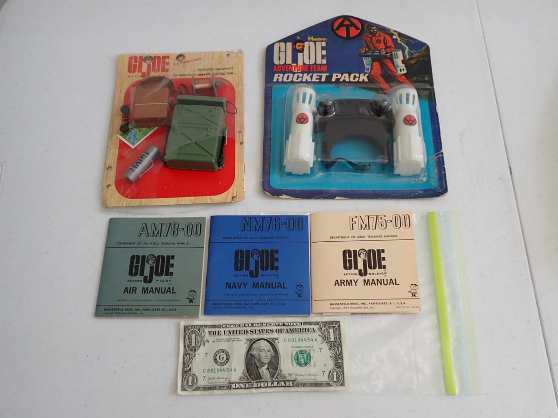 1964 GI Joe Authentic Equipment on Card, Army Manuals, etc.: Plastic has some tearing on bottom but item are still attached to the card and has training manual. 1972 Hasbro Adventure Team Rocket Pack. Plastic Torn open in lower right corner and edge & other wea