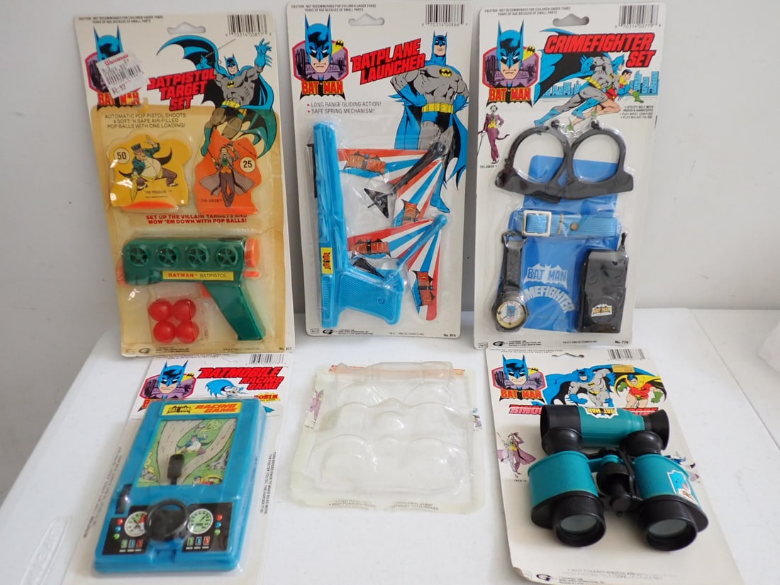 1980's Batman Toys and Game: 1988 Crime Fighter Set, 1988 Batmobile Racing Game (unpunched), 1989 Batplane Launcher - All packaged in Good Condition. 1989 Bat Pistol Target Set - Some discoloration of plastic cover and store pric