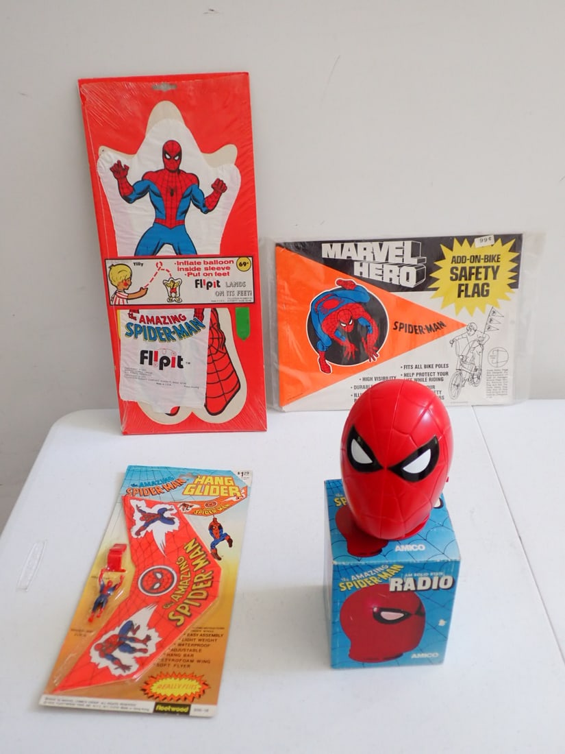 1978 Spiderman Radio in Box, Hang Glider, Safety Flag, etc.: Spider-Man Radio in Box - Radio in good condition - box has a little wear, Hang Glide on card in good condition, Safety Flag in unopened package, Flip It Balloon Toy in package with seal broken at top