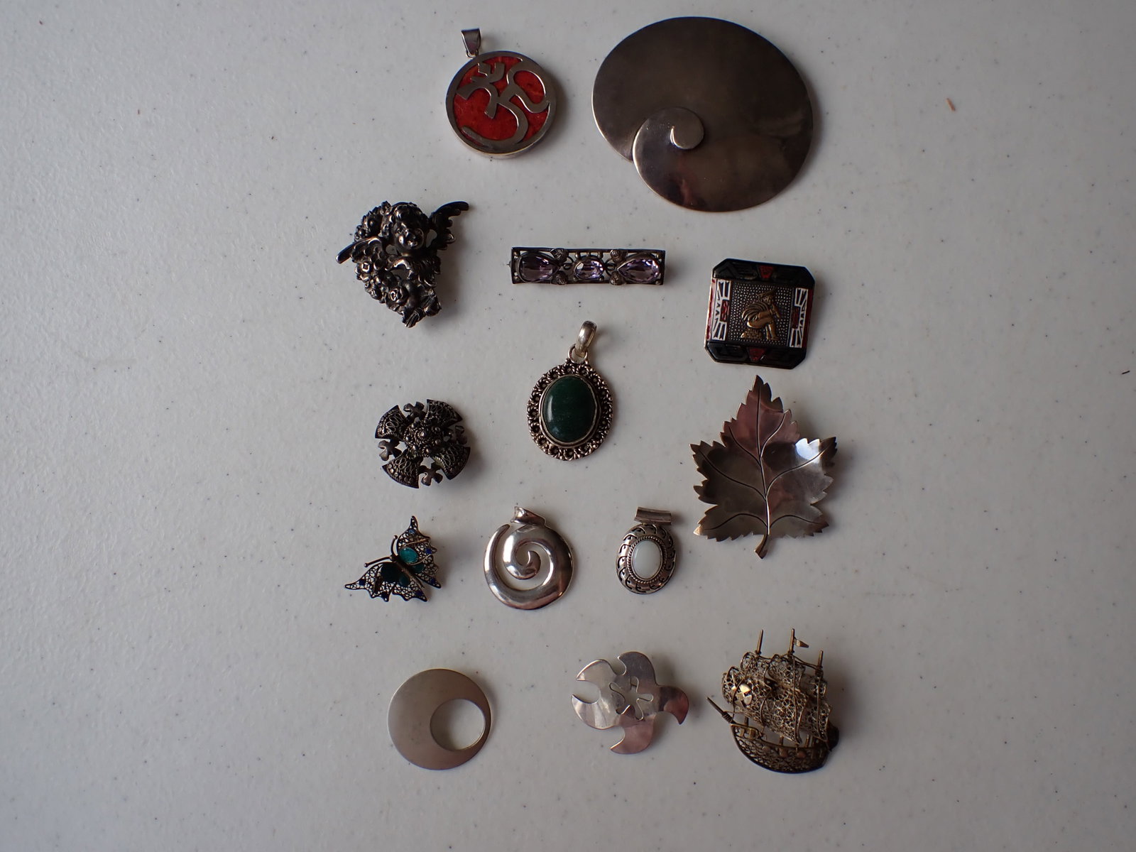 Sterling & Other Silver Pins and Pendants: Sterling Leaf Pin, Hand wrought Leaf pin, Bessette Pin, 925 Signed Peru Pin, Sterling Marked 315 Buckle, 925 Onyx Pin, Pin marked germany, 925 Asian Pendant, 800 Marked Ship Pin, ASW Sterling Pendant,