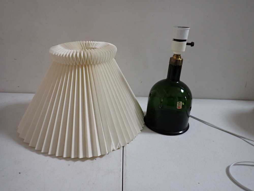 Green Glass Holmegaard - Metor C Lamp & Le Klint Shade: Green Glass Holmegaard Lamp has original label on lamp and on base. IT is 11". Shade is attributed to Le Klint and is 9". Has some creasing on shade.