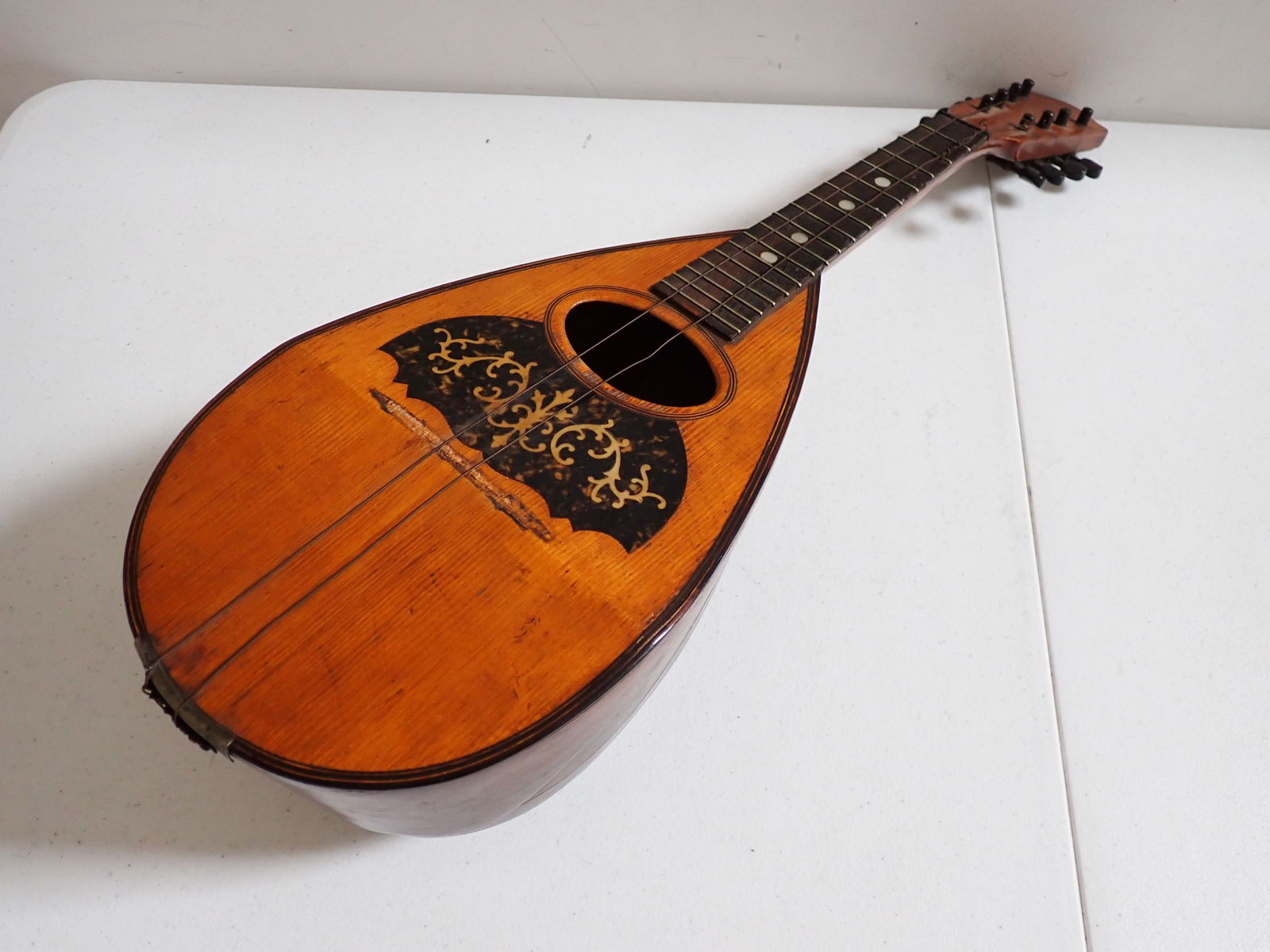 Metropolitan Academy of Music Mandolin - 24": Labeled Metropolitan Academy of Music, Scranton, PA. Has some Mother of Pearl Inlay. Has some splitting of wood sections. Missing Bridge and strings