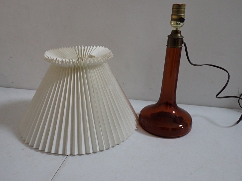 Holmgaard Brown Glass Lamp & Le Klint Shade: Brown Glass lamp is 13 1/2". Shade is 9". Lamp has some dust inside glass. Shade has some creasing. The lamp is attributed to Holmegaard and the shade is attributed to Le Klint.