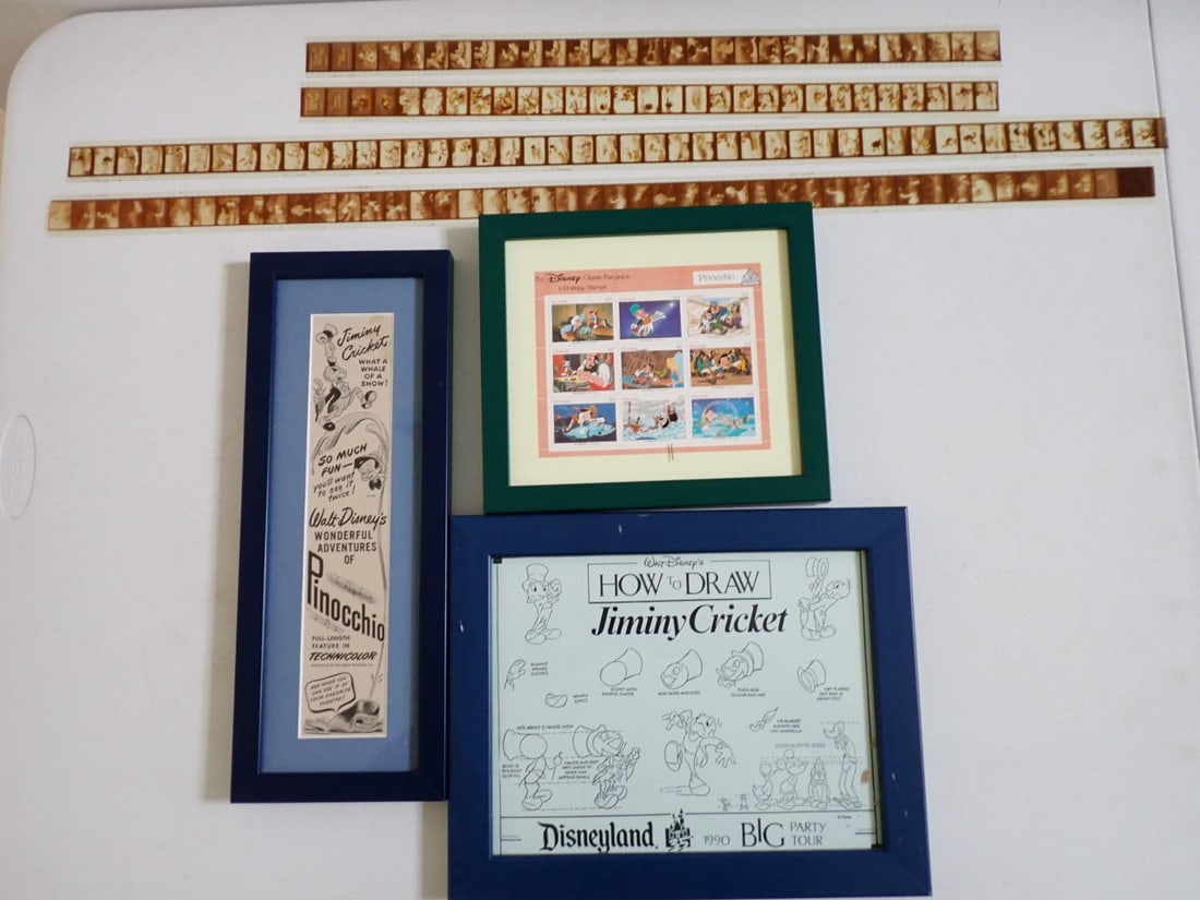 Jiminy Cricket Prints, Film Strips and Stamps: Disney How to Draw Jiminy Cricket Print. Disneyland 1990. Frame is 10 1/2" x 13", Wonderful Adventures of Pinocchio Movie Adveritising. 15 3/4" x 6", Disney Grenada Pinnochio Stamps 9" x 10" Frame & 4