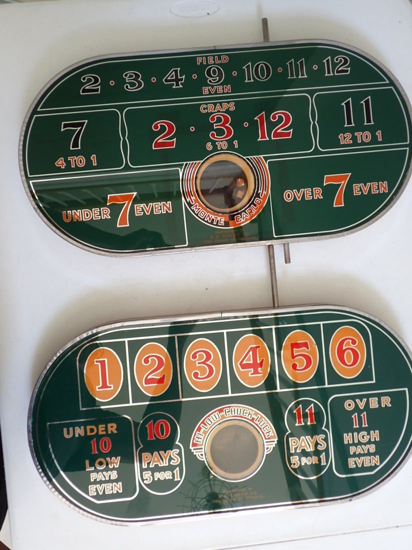 H.C. Evans Monte Carlo & Hi Low Chuck-A-Luck Tabletop Dice Games: Two Reverse Painted Games. Monte Carlo Dice Game Reverse Painted Glass w/wood frame and steel border. Pushing the bar rolls the dice. Heavily worn dice Manufactured by H. C. Evans Co. 1528 Adams St. C