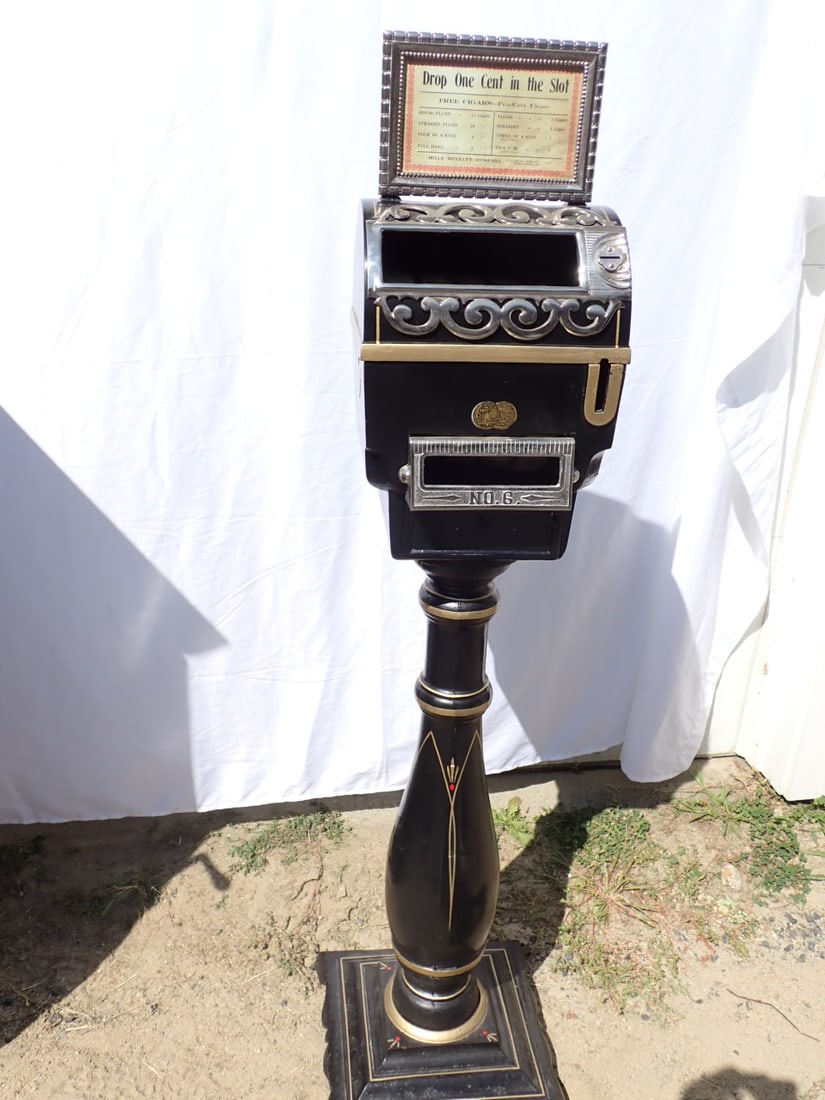 Mills Novelty Company Stand Up Metal Penny Slot Machine.: Marked No. 6 As found. Missing Mechanism and Glass Window. Also Iron on latch is broken. 38 " High