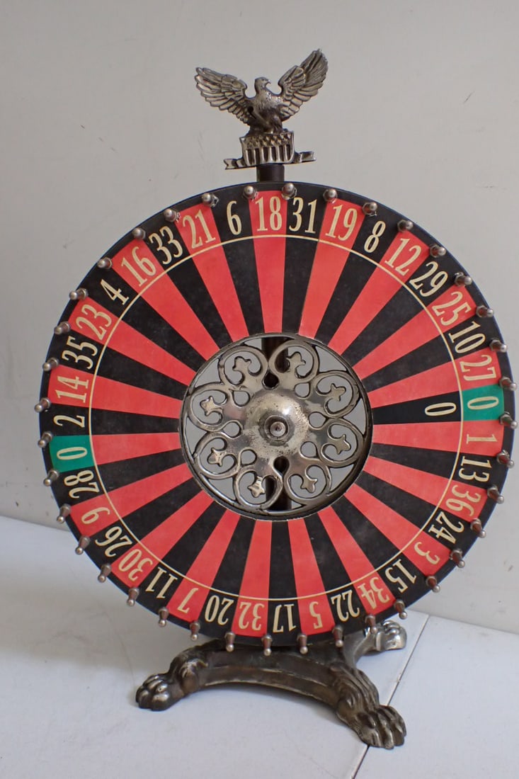 Roulette wheel with Nickel plated base and Eagle: Roulette Prize wheel. Wheel is 14" diameter, has nickel base with paw feet. Overall height is 19".Eagle design on top. Center of wheel is nickel plated. Dial is missing.