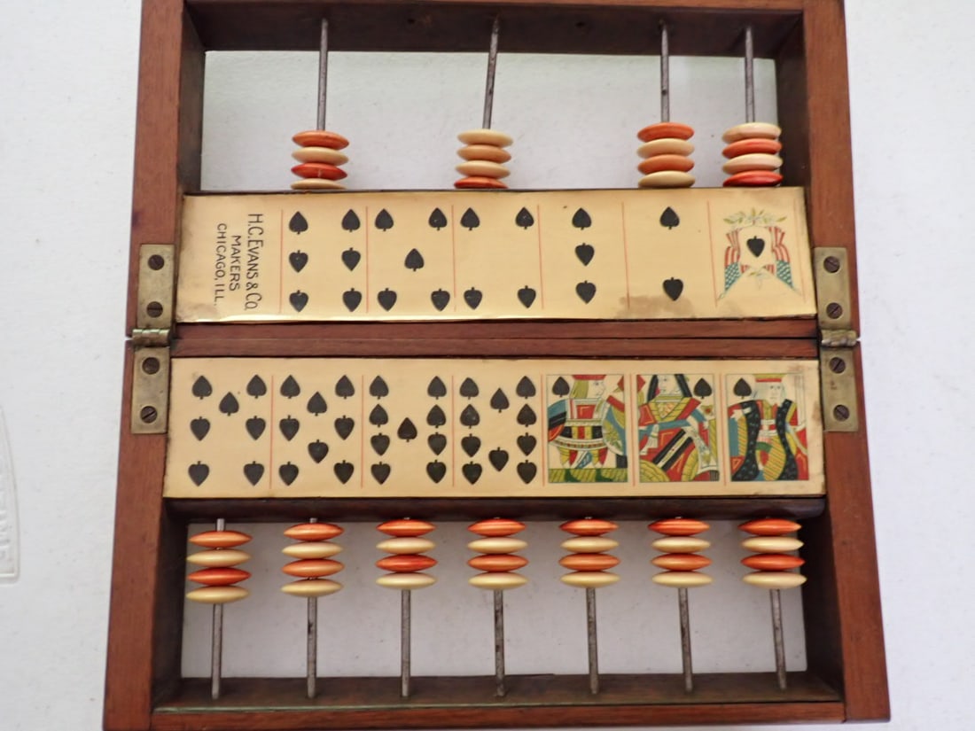 H. C. Evans & Co. Spades Game Score Keeper: H. C Evans & Co. Makers, Chicago, Ill. Vintage Spades Game Score Keeper. Has 4 plastic discs on bars to keep score. Missing 2 Spindles and discs. Some staining on card designs. Wood case is detached i