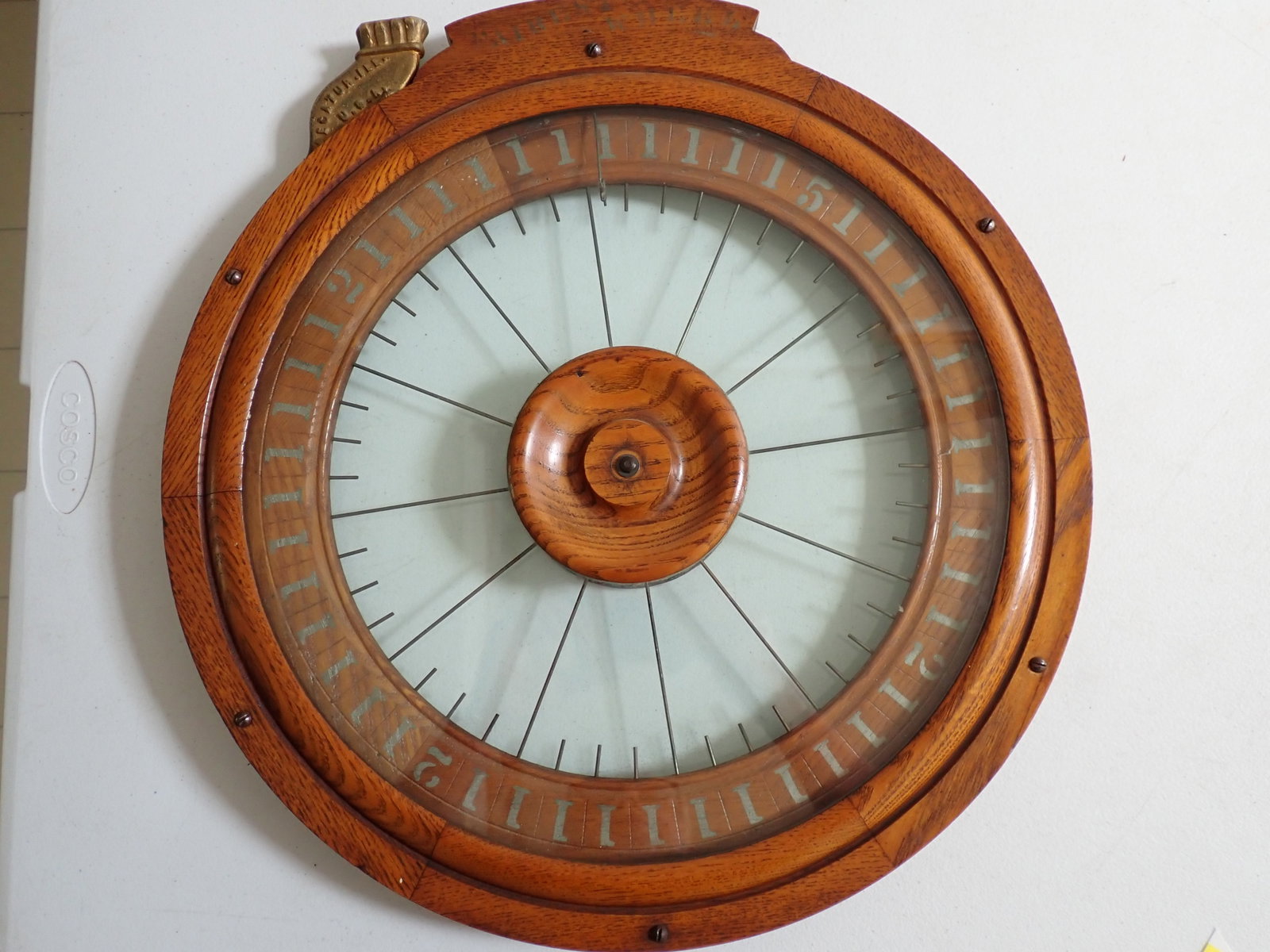Fairest Wheel Trade Stimulator: Oak case wheel marked "Fairest Wheel" at top. Iron coin slot Marked "Decatur Fairest Wheel Works". The wheel has numbers 1, 2 and 5. Whatever number the wheel stopped at was the number of cigars you w