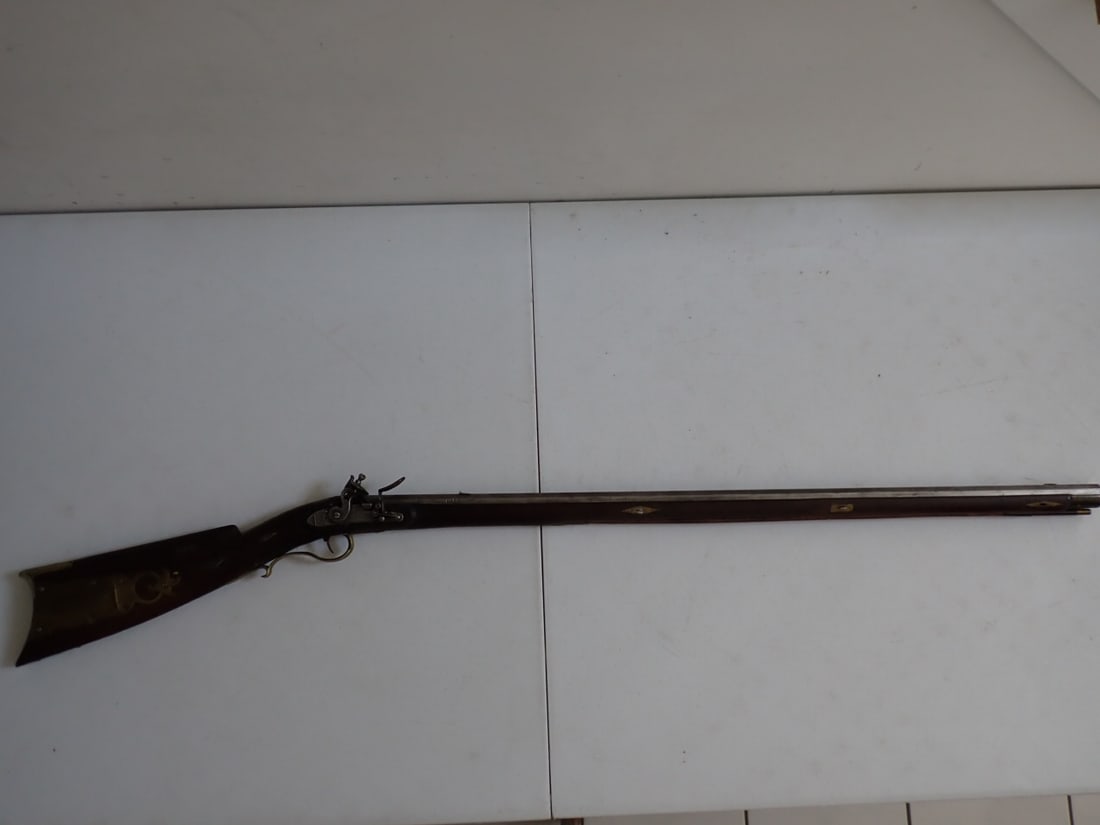 J. Perry Kentucky Long Rifle: "J. Perry Warranted." Engraving on lock plate and on brass pieces. 50" Length. 35" Barrel. A little wear. Trigger mechanism works.