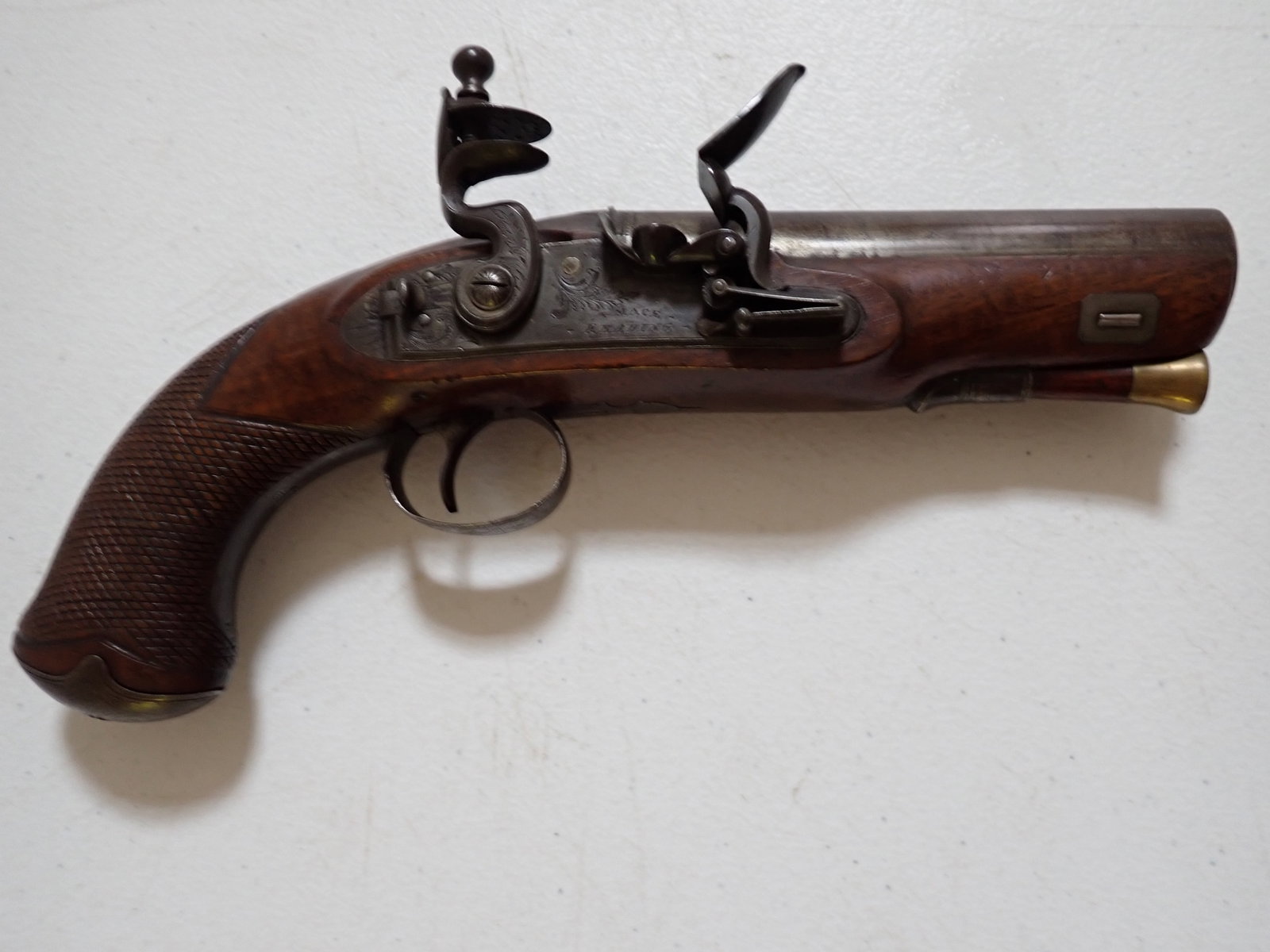 T Mace .65 Caliber English Flintlock Pistol: Marked "T. Mace Reading." Engraved. 9". 4 1/2" Barrel. Good condition. Trigger mechanism works.