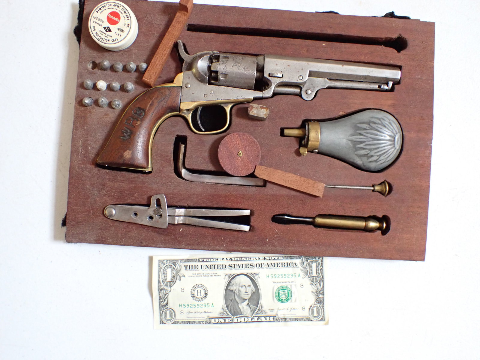 Colt Revolver and accessories: Barrel Marked "Address Col. Sam'l Colt New York US Amer." Matching Serial numbers on gun 220799. Also has Powder Flask, bullets and tools. Initials W.R.O. Carved in grip. Trigger mechanism works. Has 