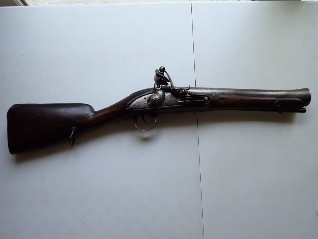 East India Co. Blunderbuss with London Proofs: Estate paperwork states that this is an East India Co. gun with London proofs. We photographed the marks. 26 1/2". 12 1/4" barrel. Some cracks and chipping of stock and natural discoloration of metal.