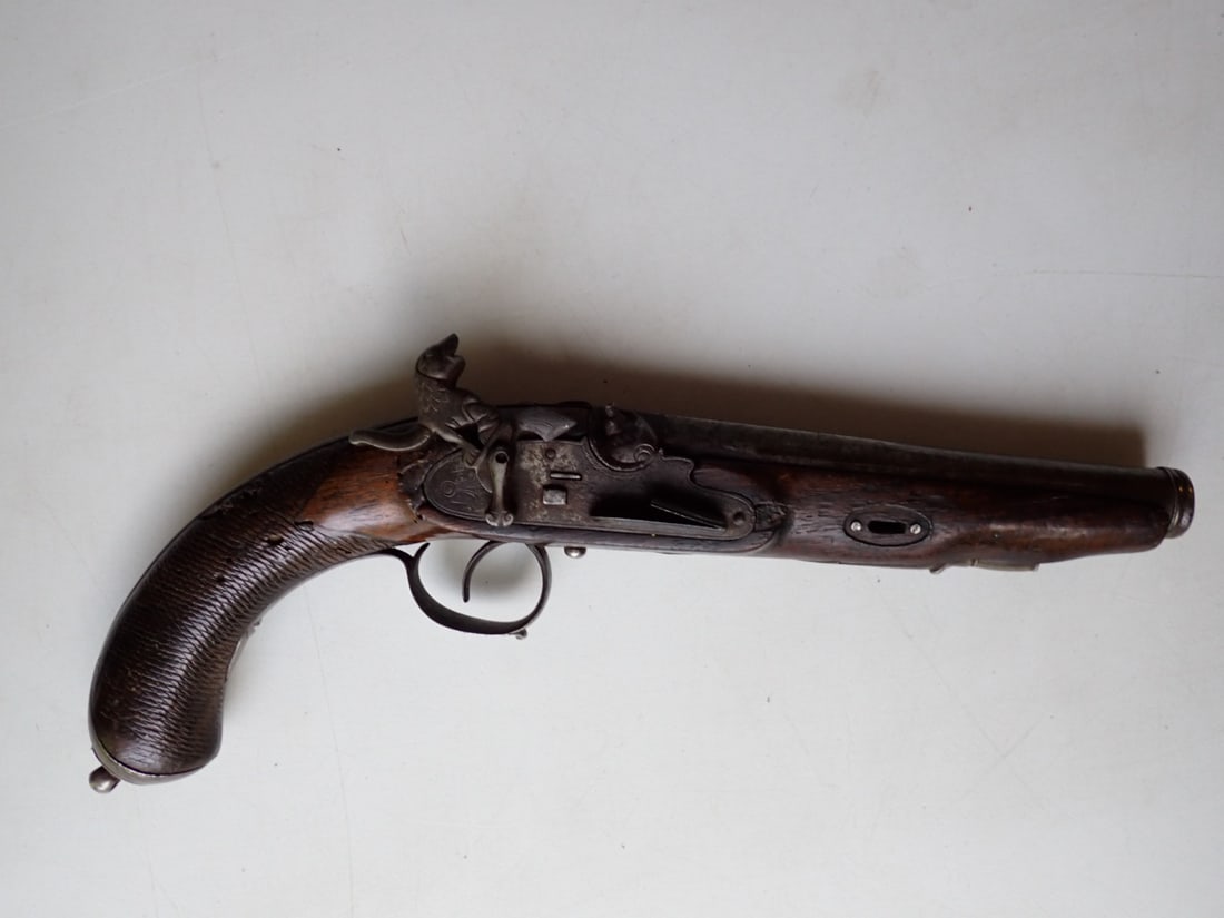 1840 De Julio Granada, Spain Pistol with Animal Design Hammer: Signatures on Barrel. Paperwork from estate describes it as made by "Arechabeleta De Julio" in 1840. Grenade (So. Spain). 13" Overall length. Has some wear with holes in Grip.