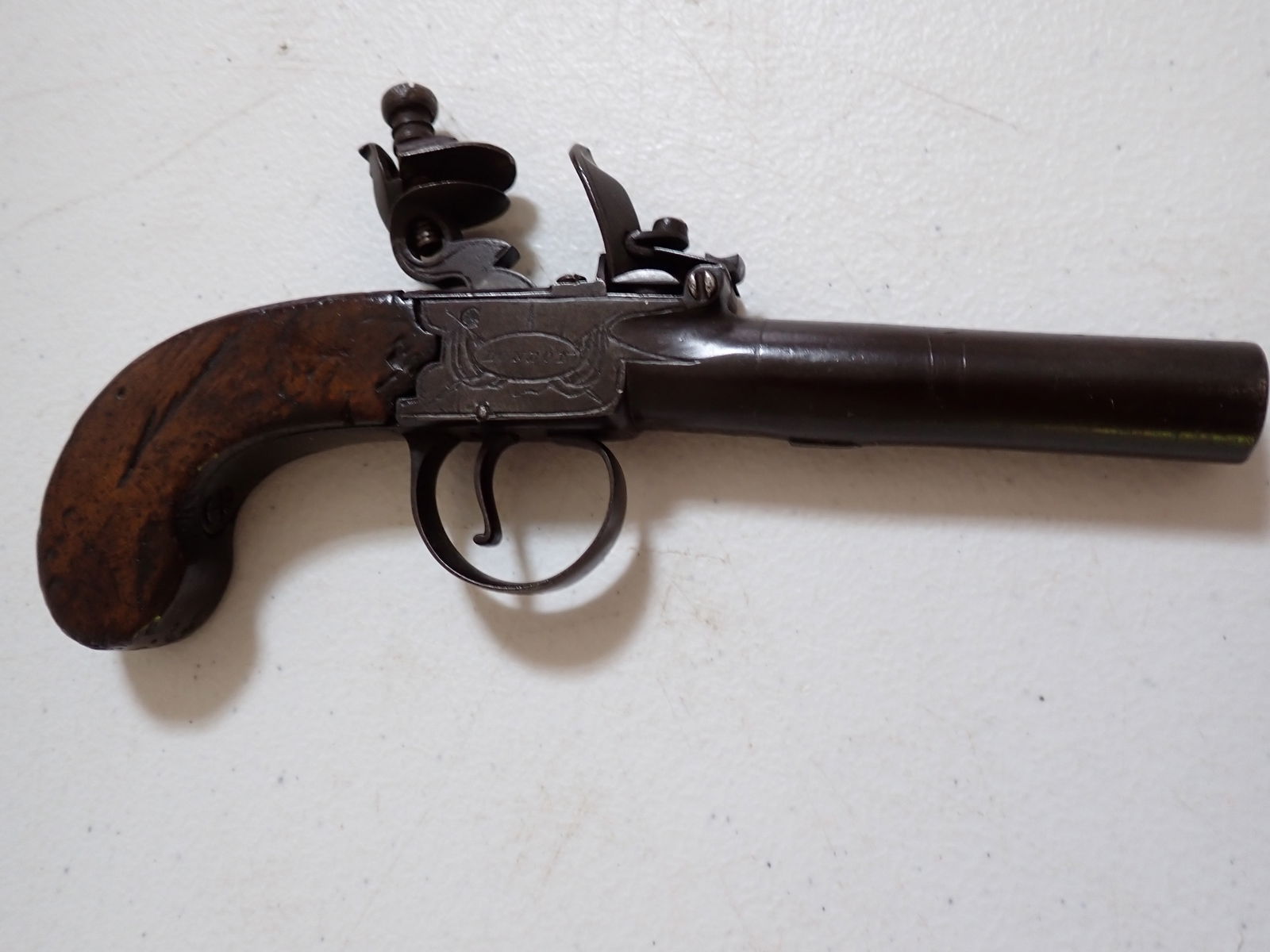 Twigg English Antique Flintlock Pistol: Marked "Twigg" on one side and "London" on the other. Estate paperwork lists it as 1764-1801. 7". Barrel 3". Trigger mechanism works. Some wear with marks on grip.