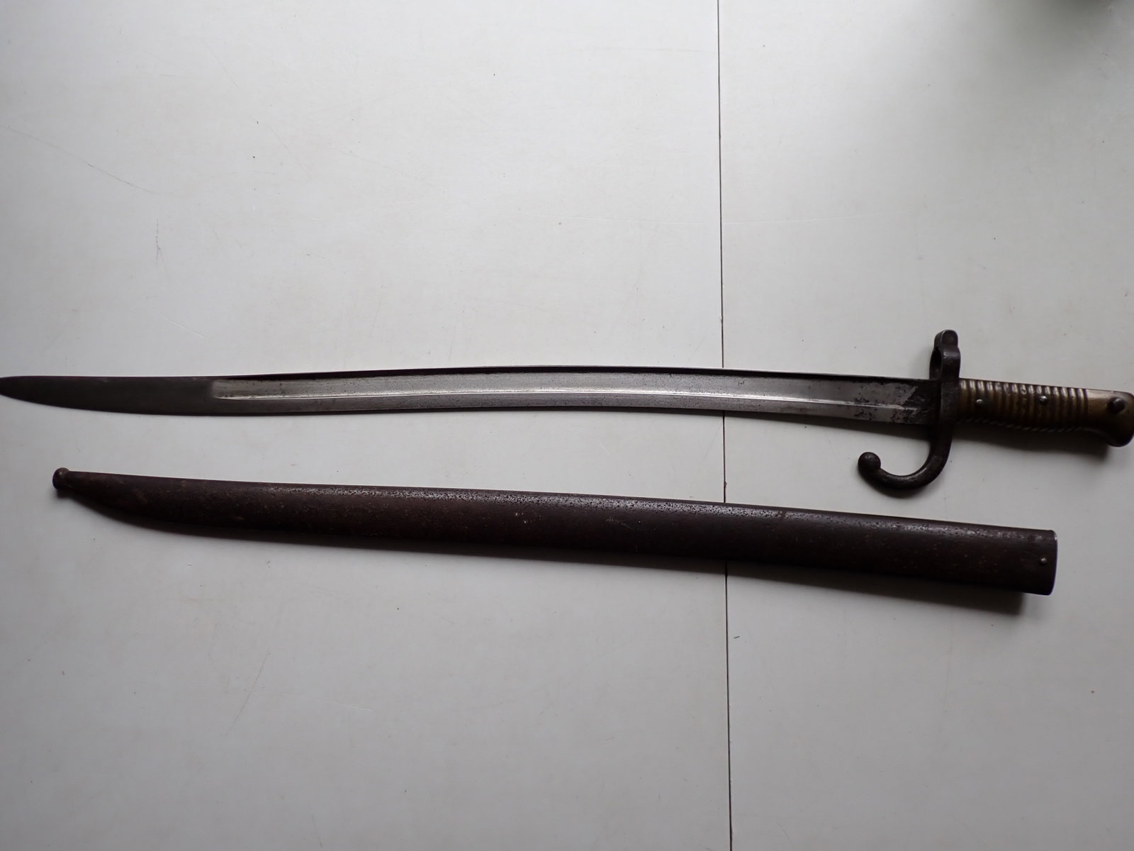 French 19th Century Bayonet: Marked T 57469. 27" Bayonet (excluding sheath). 22 1/2" Blade. Some wear most noticeable on blade near finial.