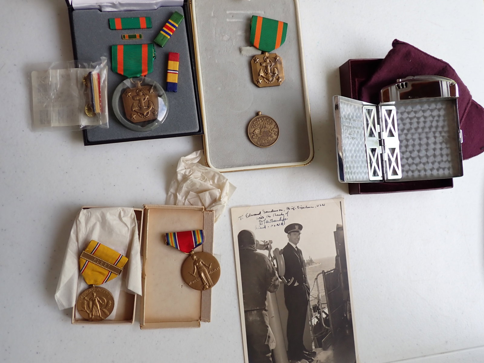 Naval Medals, Engraved Cigarette Case, and Douglas Fairbanks Jr. signed Photo: Ronson Cigarette Case / Lighter Monogrammed Lt. JG Edward Sanderson USN Commanding Officer USS LSFF 790 From the Crew. Has some wear. Douglas Fairbanks Jr. in Uniform signed D. Fairbanks Jr. Lieut. US